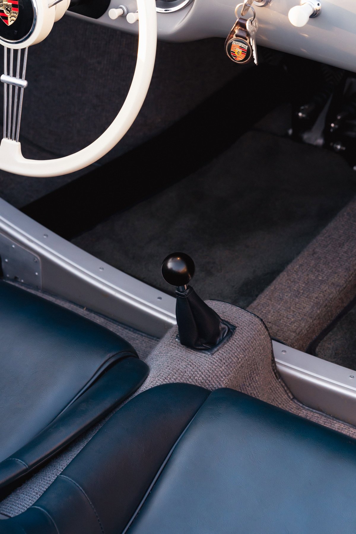Interior shot of a Beck 550 Spyder with a classic white steering wheel and black shift knob.
