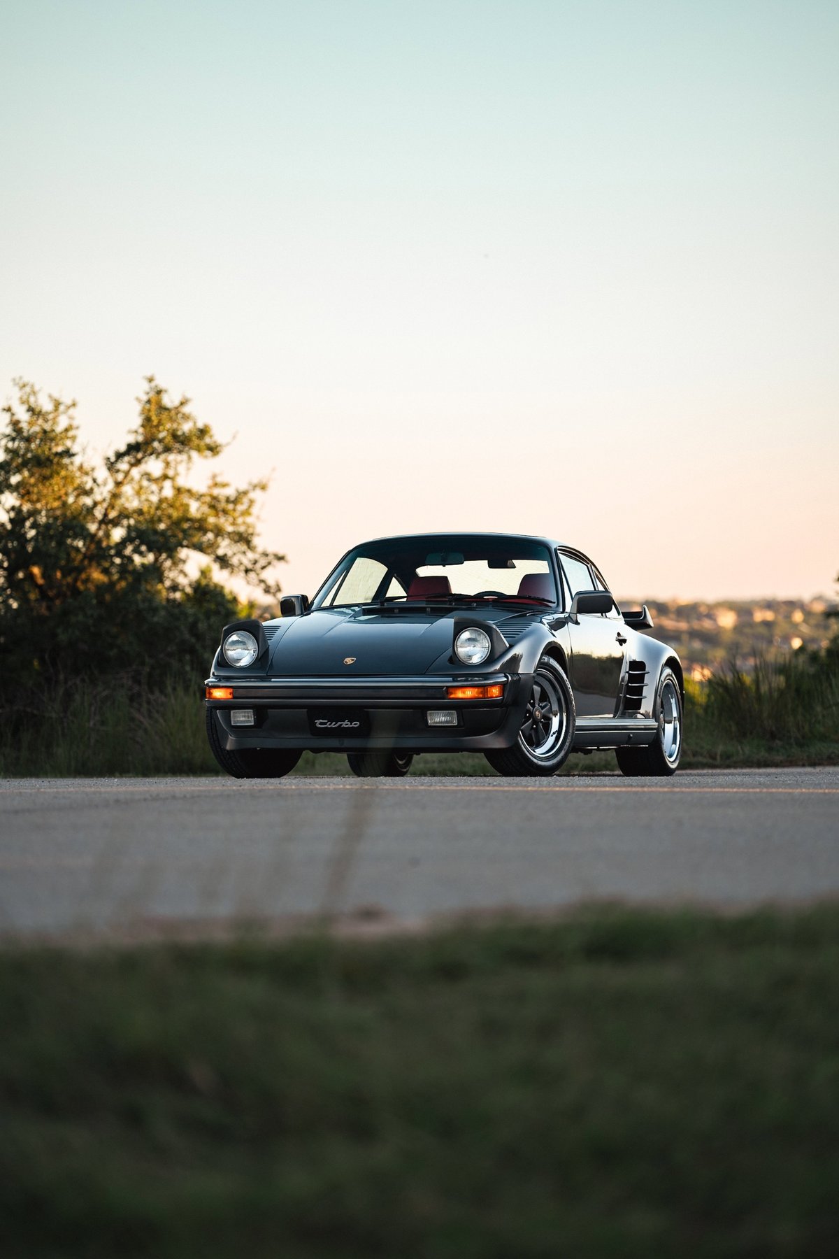 1989 Porsche 930 Turbo Flachbau coupe in Slate Grey Metallic with red interior.