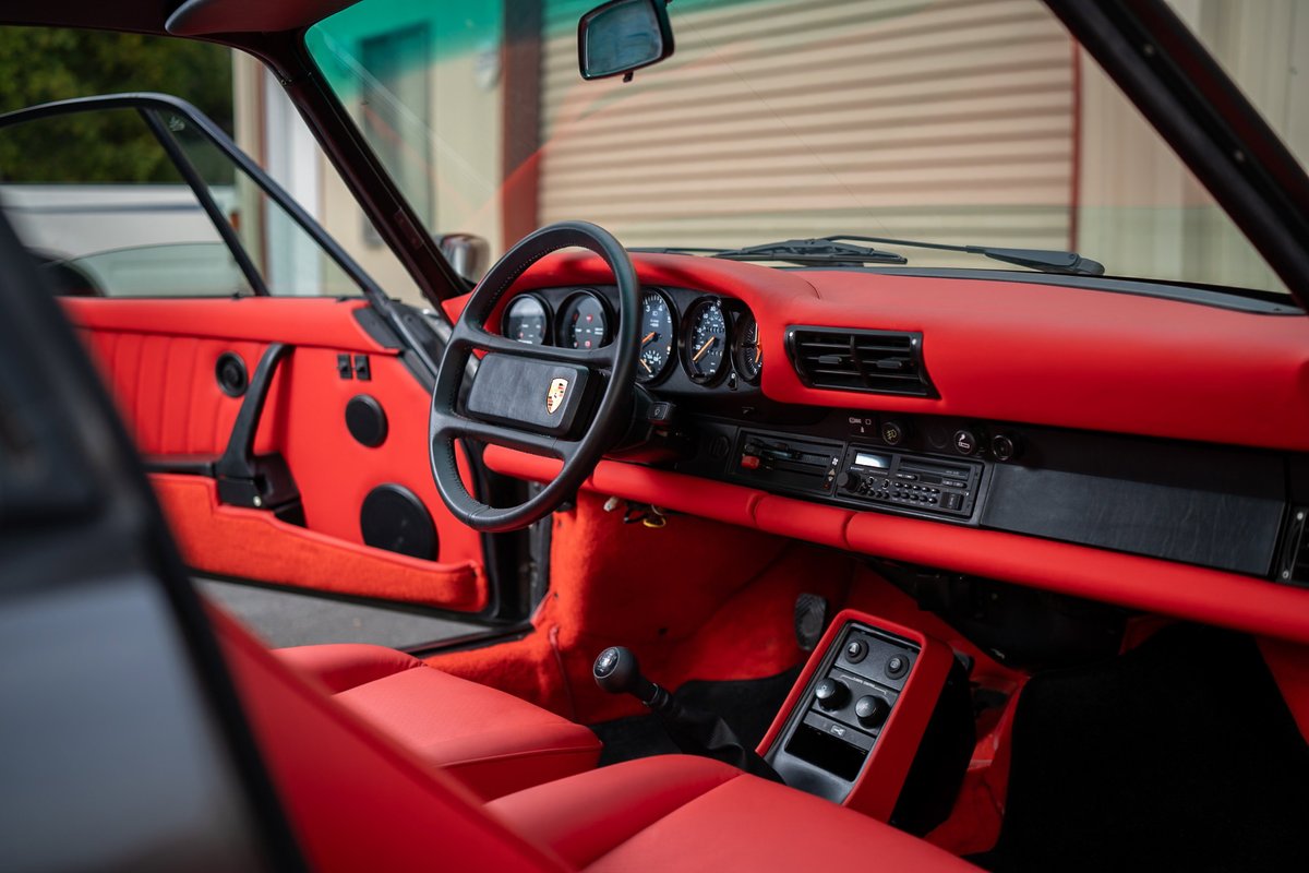 1989 Porsche 930 Turbo Flachbau interior with red leather trim and door panels.