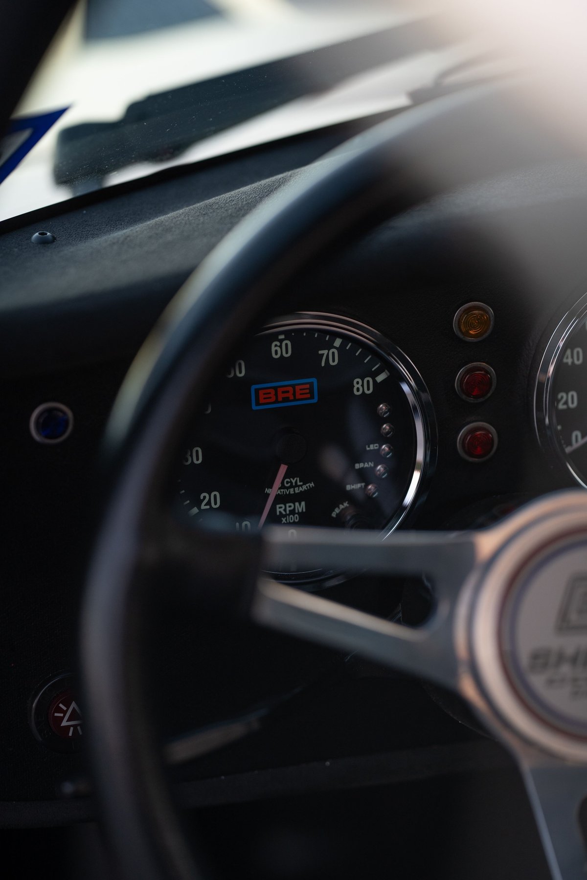 Classic 1965 Superformance Shelby Daytona CSX Coupe dashboard with BRE tachometer.