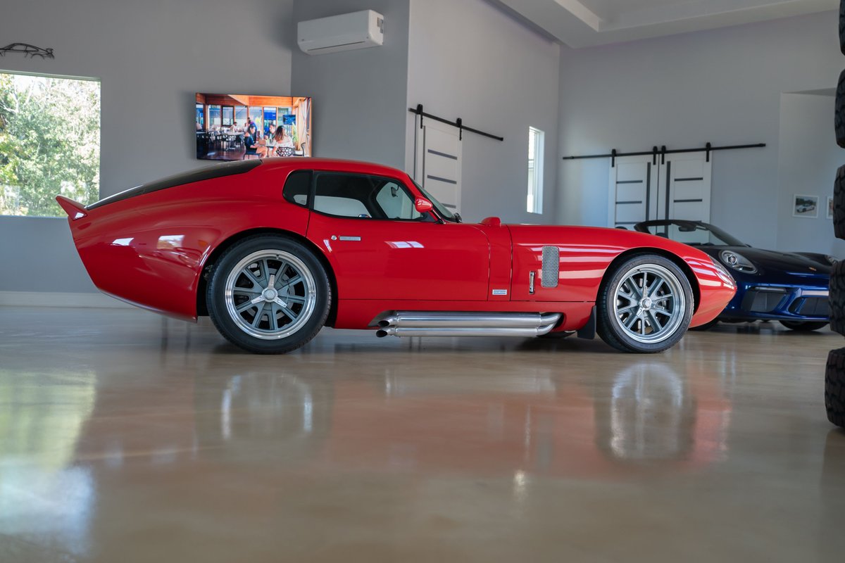 Red 1965 Superformance Shelby Daytona CSX with chrome-finished multi-spoke rims.