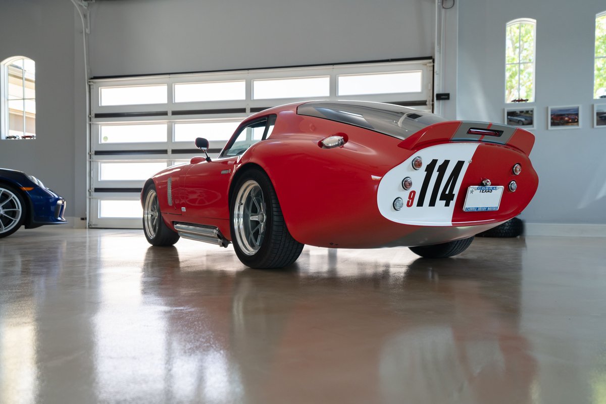 Red 1965 Superformance Shelby Daytona CSX with racing livery, custom rims, and a prominent "114" number plate.