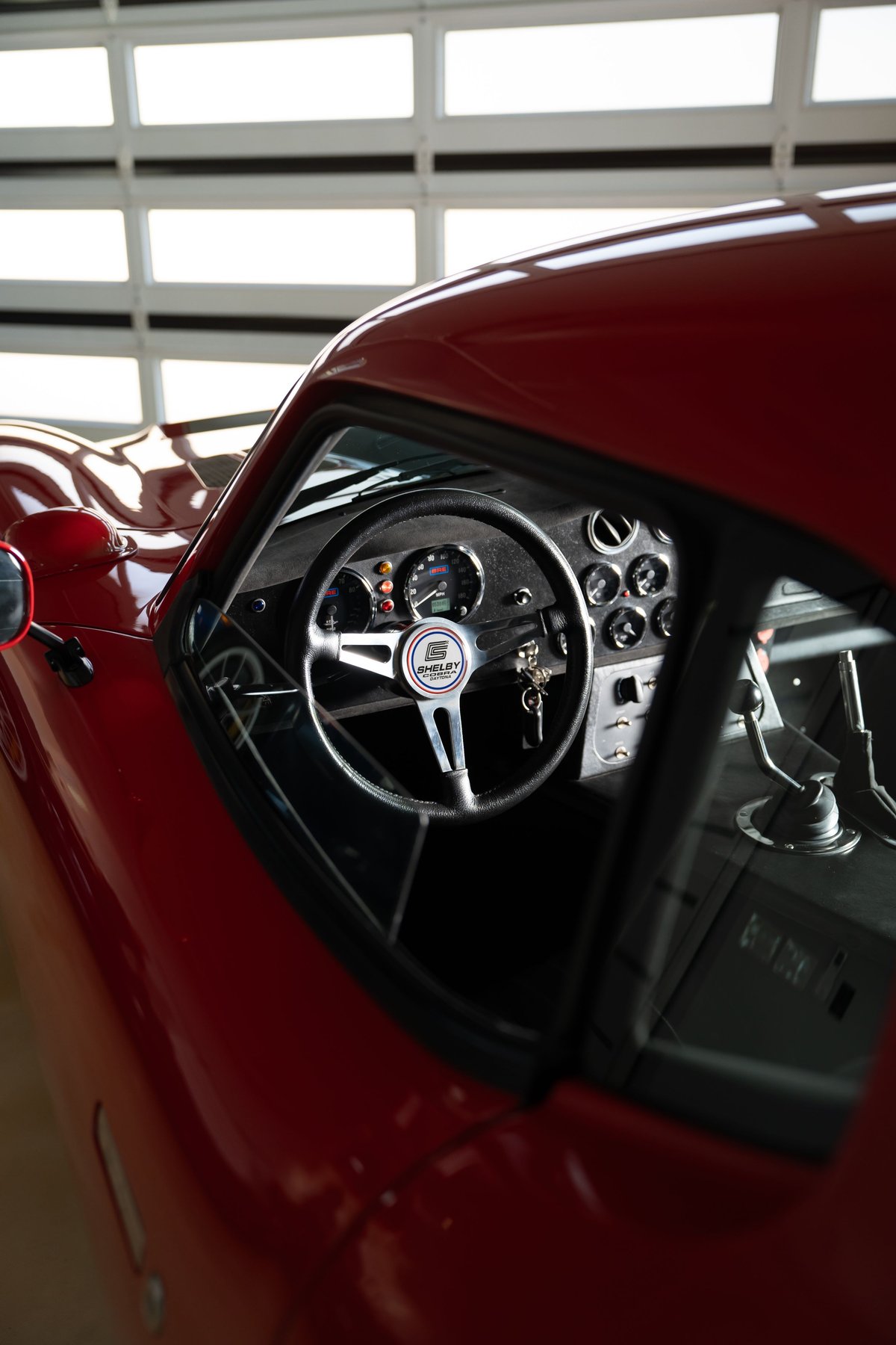 Monza red 1965 Superformance Shelby Daytona CSX interior with Shelby steering wheel and gauges.