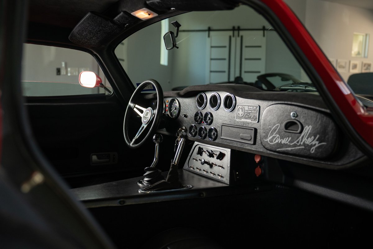 1965 Superformance Shelby Daytona CSX in Monza Red. Interior features vintage steering wheel & Shelby signature.