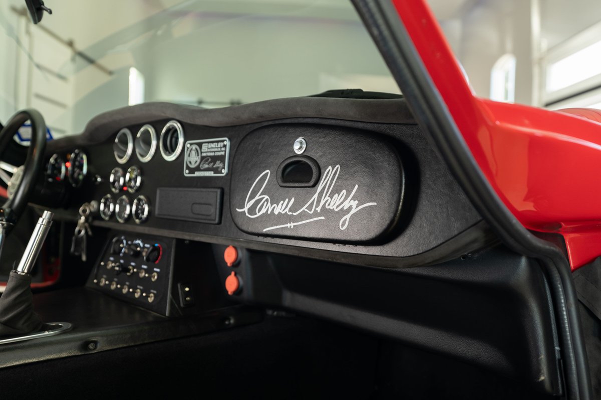 Close-up of the Shelby Daytona's dash, featuring Carroll Shelby's signature and a plaque.