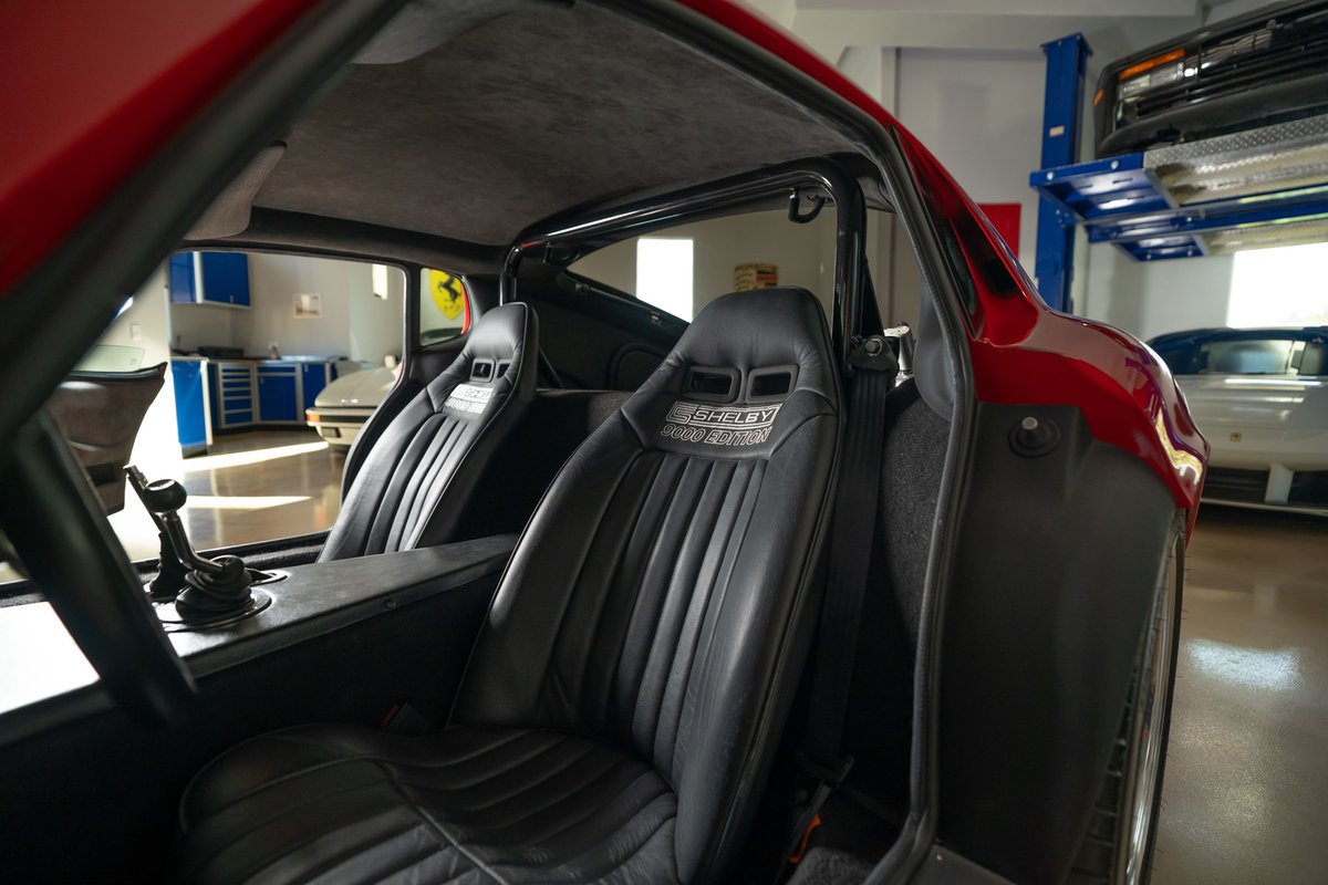 1965 Superformance Shelby Daytona CSX interior, red exterior, black racing seats with Shelby branding.