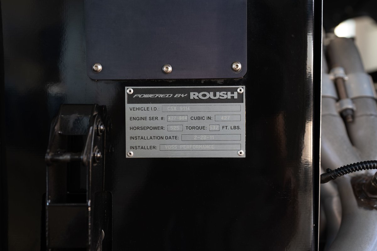 Close-up of a Roush Performance VIN plate on a red 1965 Shelby Daytona CSX.