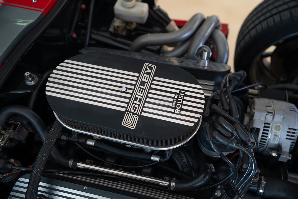 Roush-powered Shelby Daytona Cobra Coupe engine bay in Monza Red. Features a Shelby air cleaner.