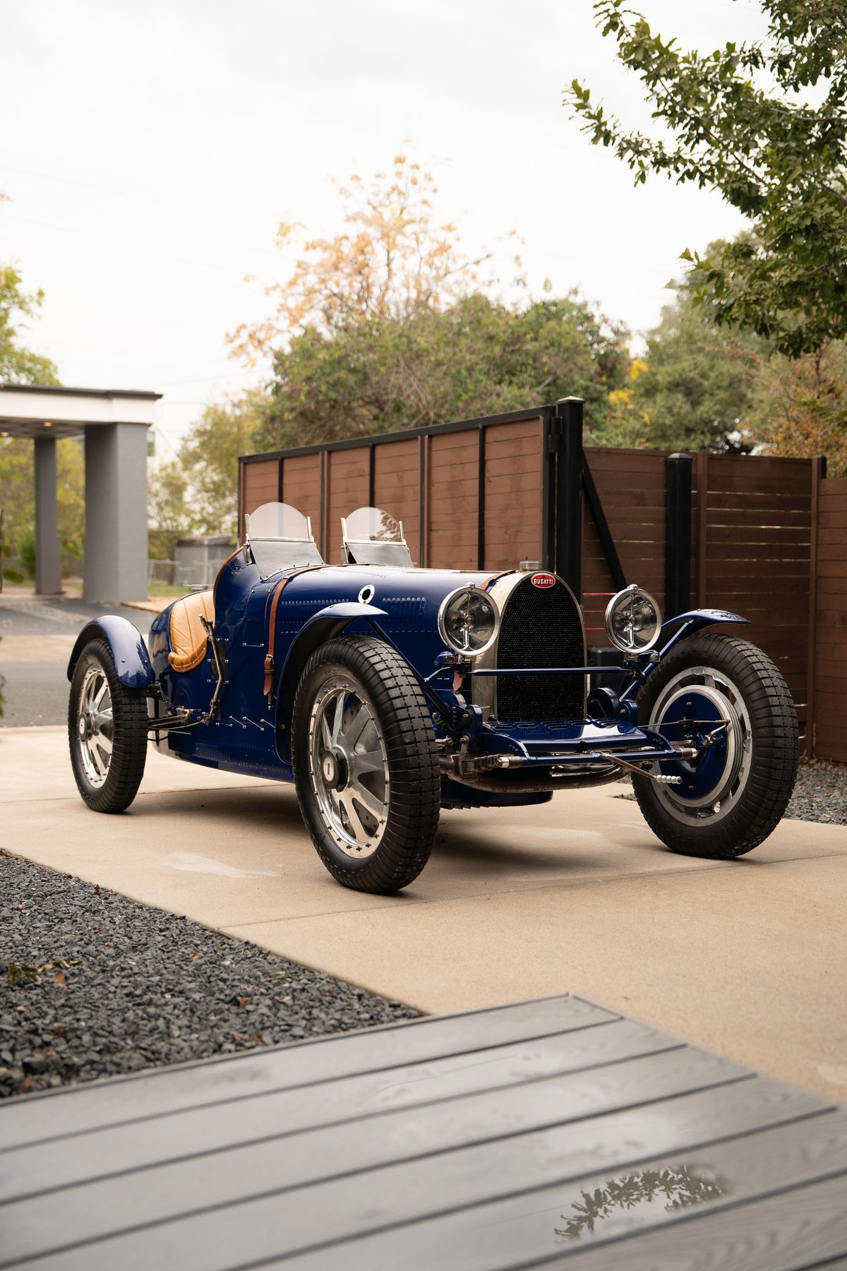 A blue 1927 Pur Sang Bugatti Type 35 with classic spoked rims.