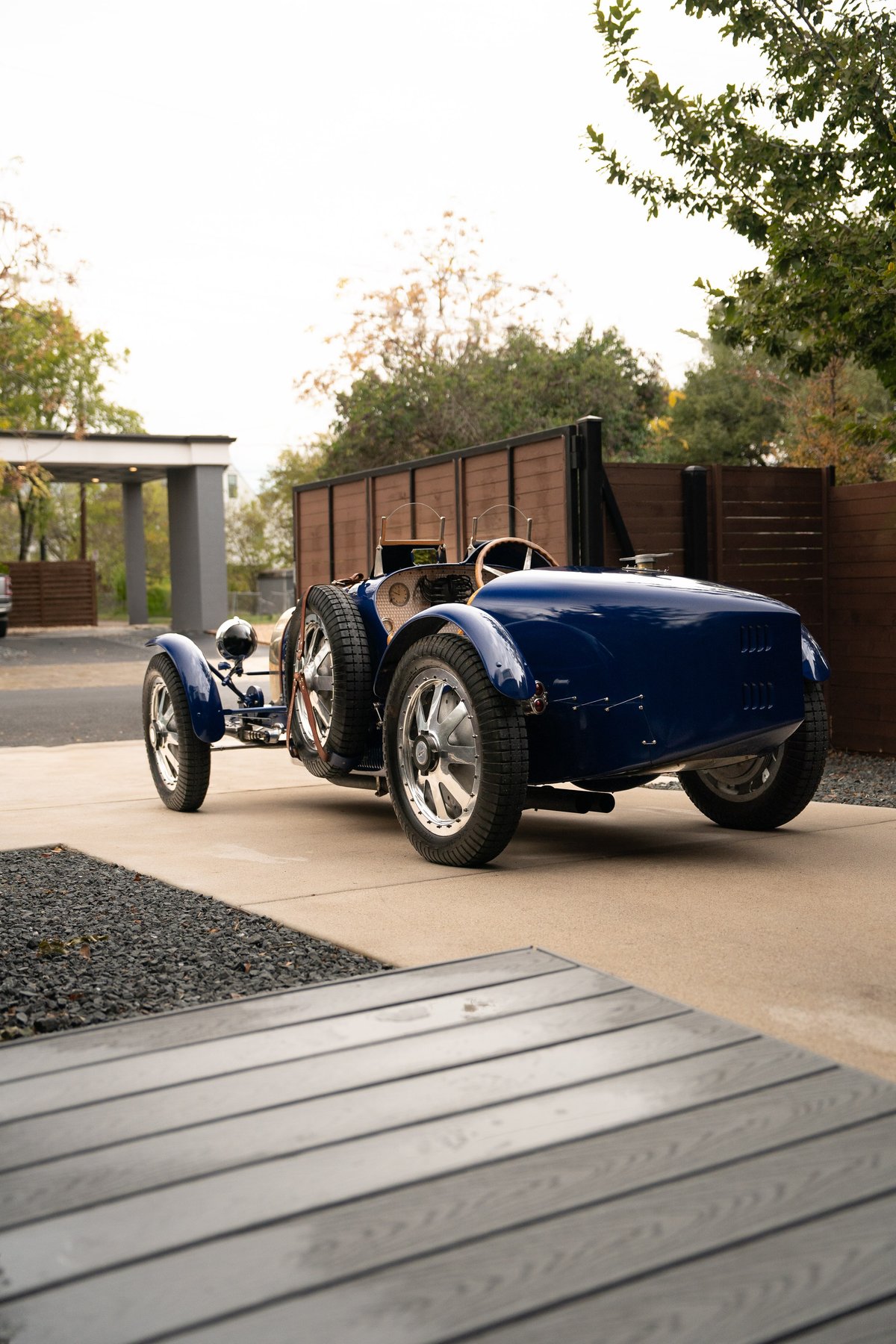 A blue 1927 Bugatti Type 35 Pur Sang. This vintage race car features wire-spoke rims and exposed leather seat trim.