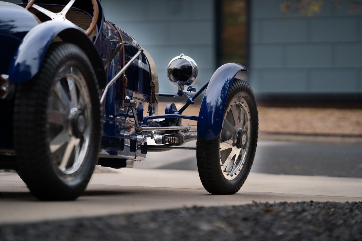 Blue 1927 Pur Sang Bugatti Type 35, showing intricate chrome trim and polished rims.