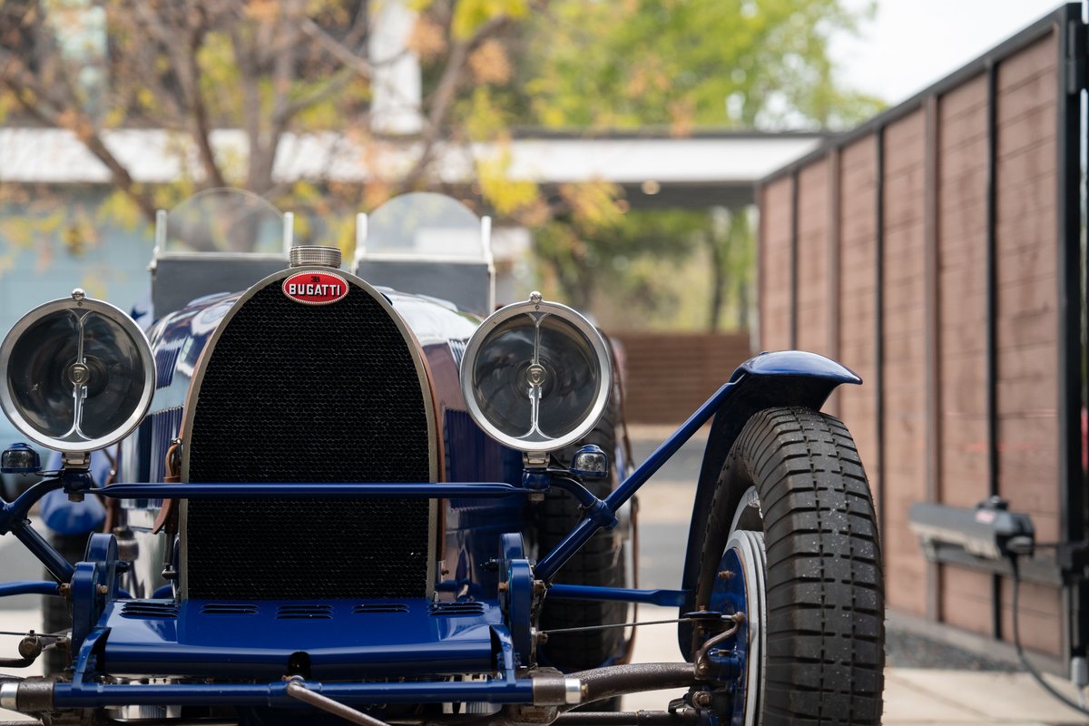 Blue 1927 Bugatti Type 35 Pur Sang with prominent grille, dual headlamps, and vintage wire-spoke wheels.