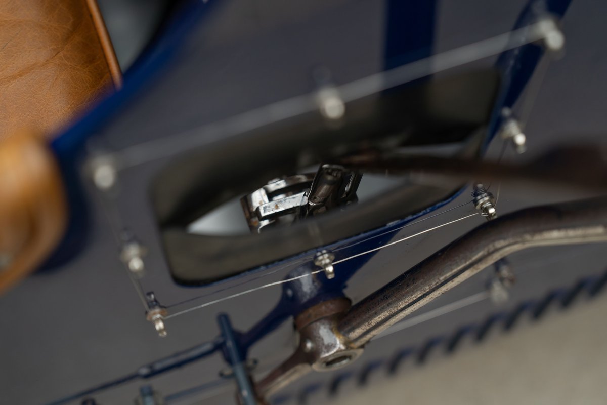 Detail of a blue 1927 Bugatti Type 35 steering column and foot pedals.