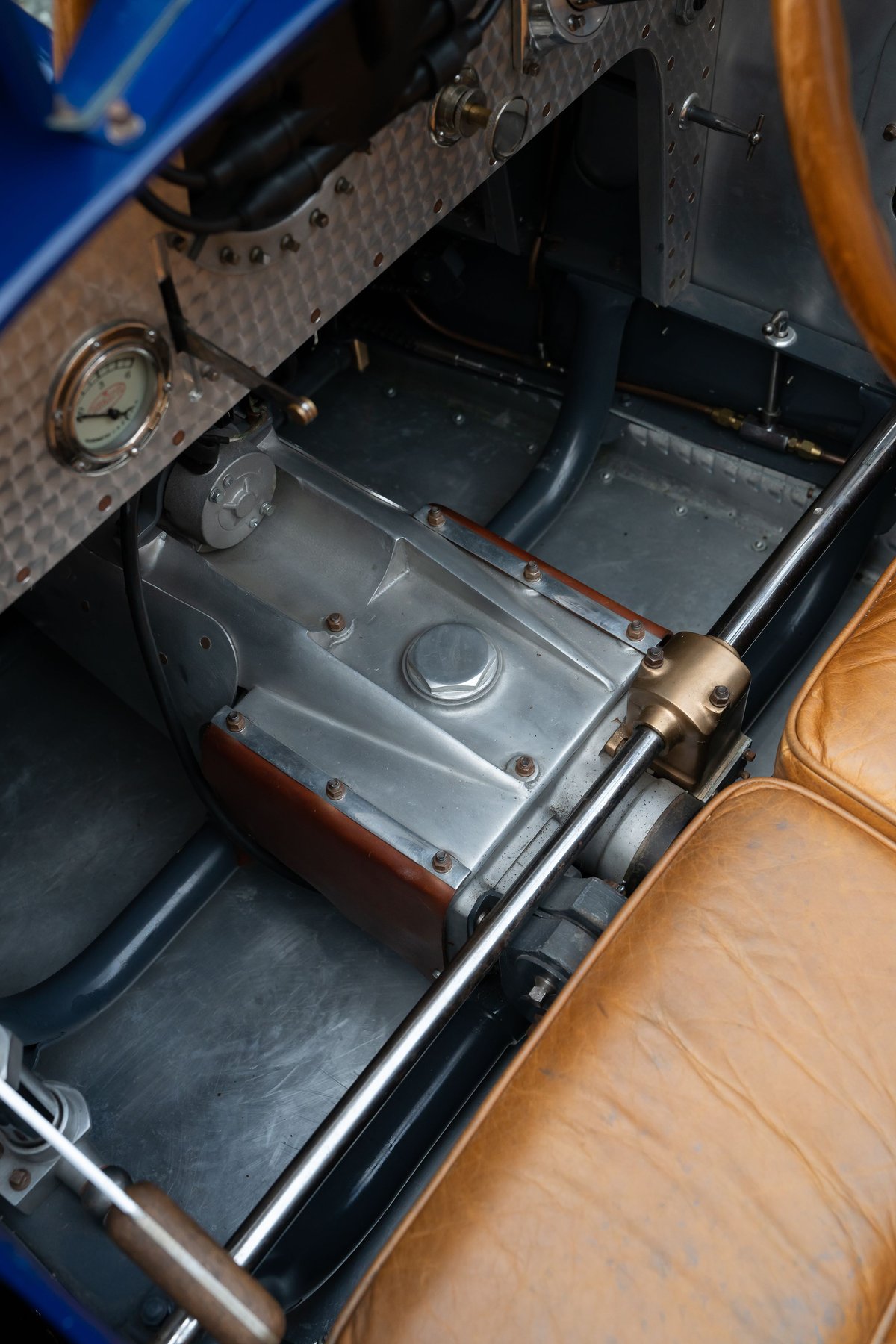 Close-up of the vintage blue 1927 Pur Sang Bugatti Type 35 interior. Features polished metal trim & tan leather seats.