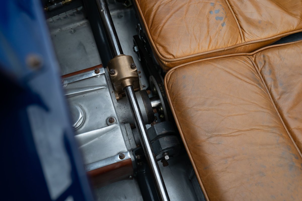 Close-up of tan leather interior and drive shaft mechanism in a blue 1927 Bugatti Type 35 Pur Sang.