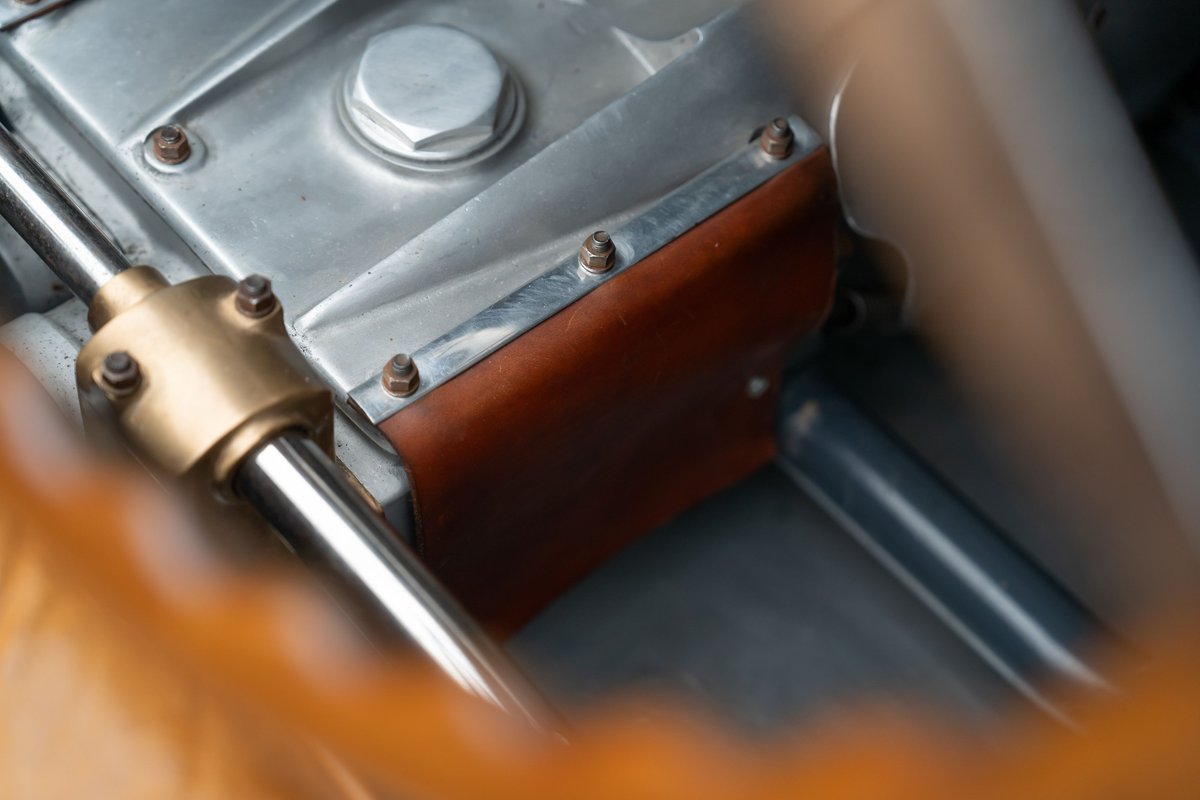 Vintage Bugatti Type 35 transmission tunnel with leather trim and a brass bearing.
