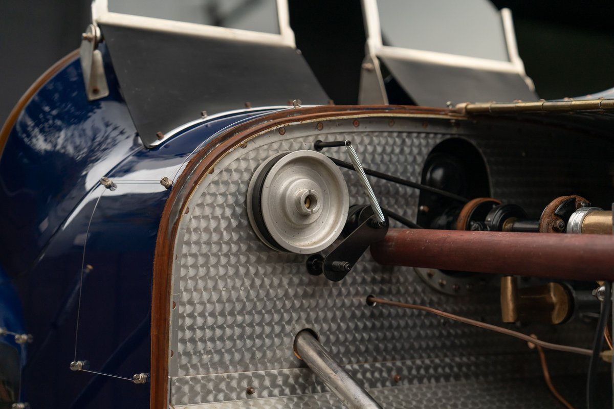 Close-up of a vintage blue 1927 Bugatti Type 35 engine bay with a pulley system.