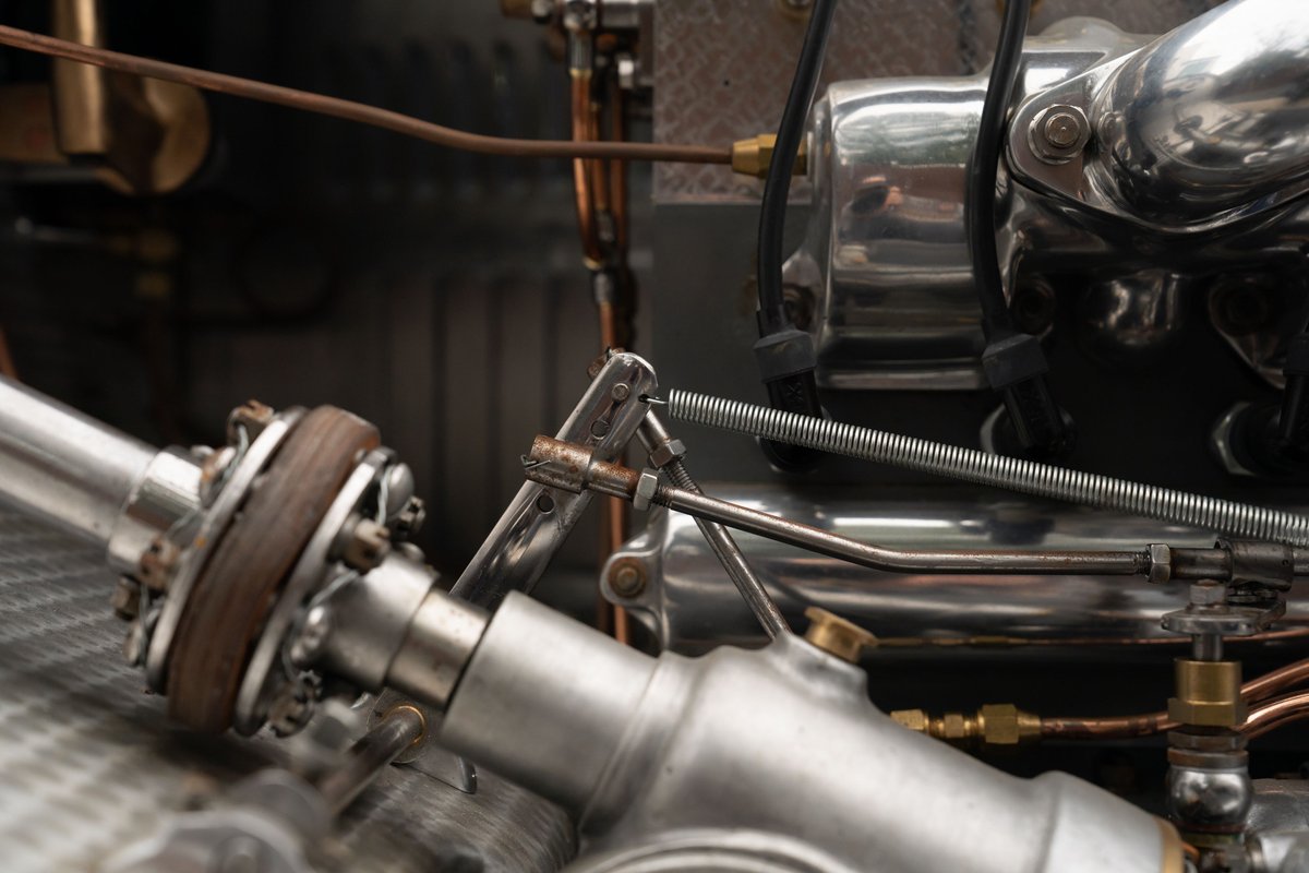 Close-up of the intricate drivetrain of a vintage blue 1927 Bugatti Type 35.