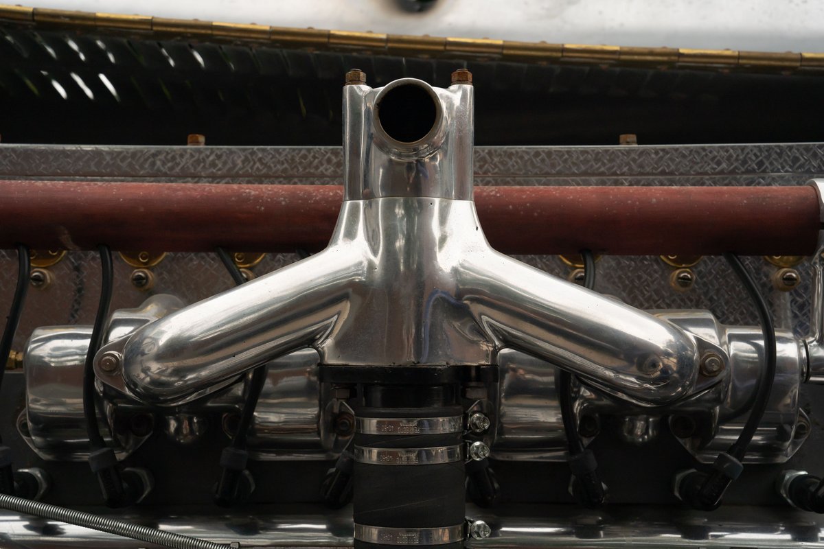 Close-up of a polished aluminum intake manifold on a 1927 Bugatti Type 35 engine.