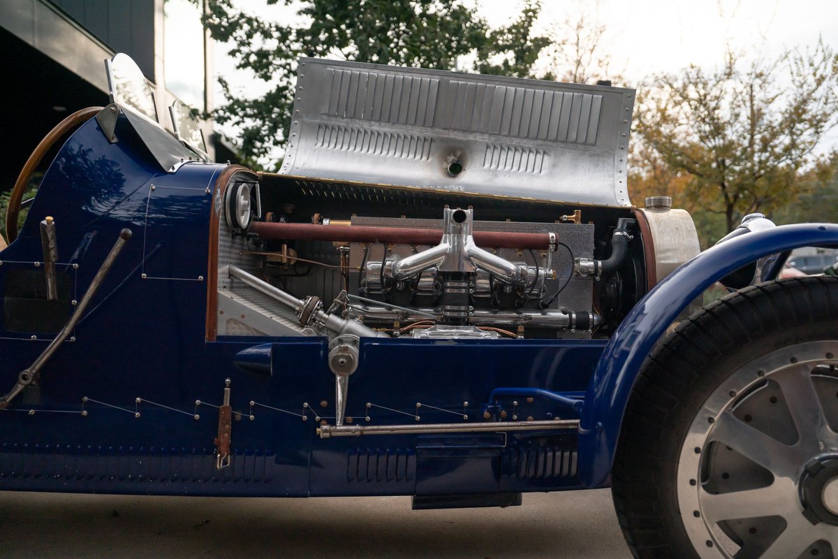 Blue 1927 Bugatti Type 35 Pur Sang with exposed V12 engine and silver wire-spoke rims.