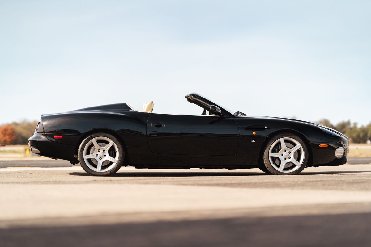 Black 2003 Aston Martin DB AR1 Zagato convertible. Features polished five-spoke alloy rims and tan interior.