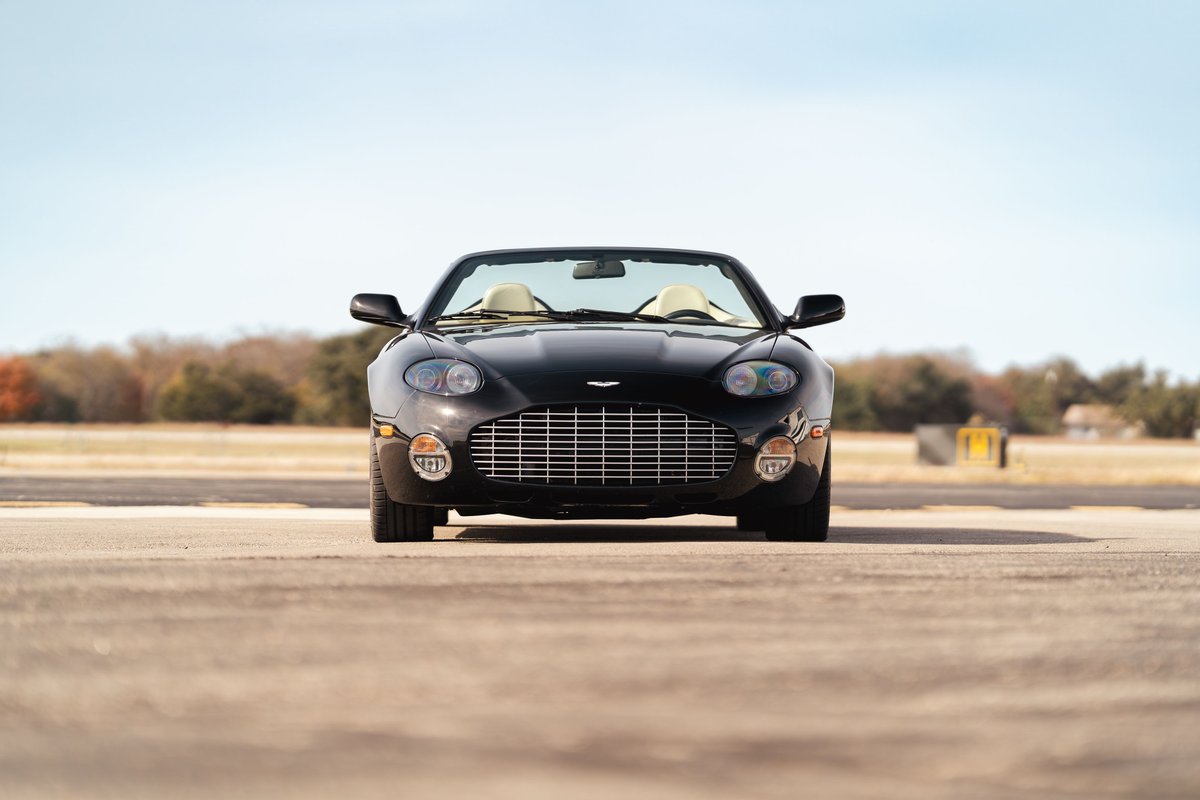 Black 2003 Aston Martin DB AR1 Zagato convertible with tan interior and chrome grille.