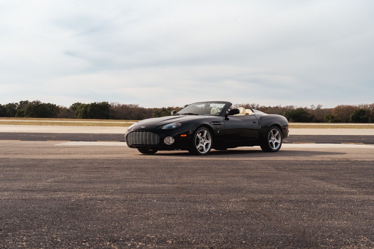 Black 2003 Aston Martin DB AR1 Zagato convertible with tan interior and silver rims.