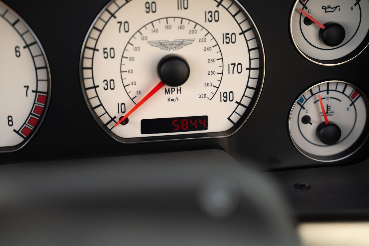 Close up of a 2003 Aston Martin DB AR1 Zagato dashboard, showing speedometer and gauges.