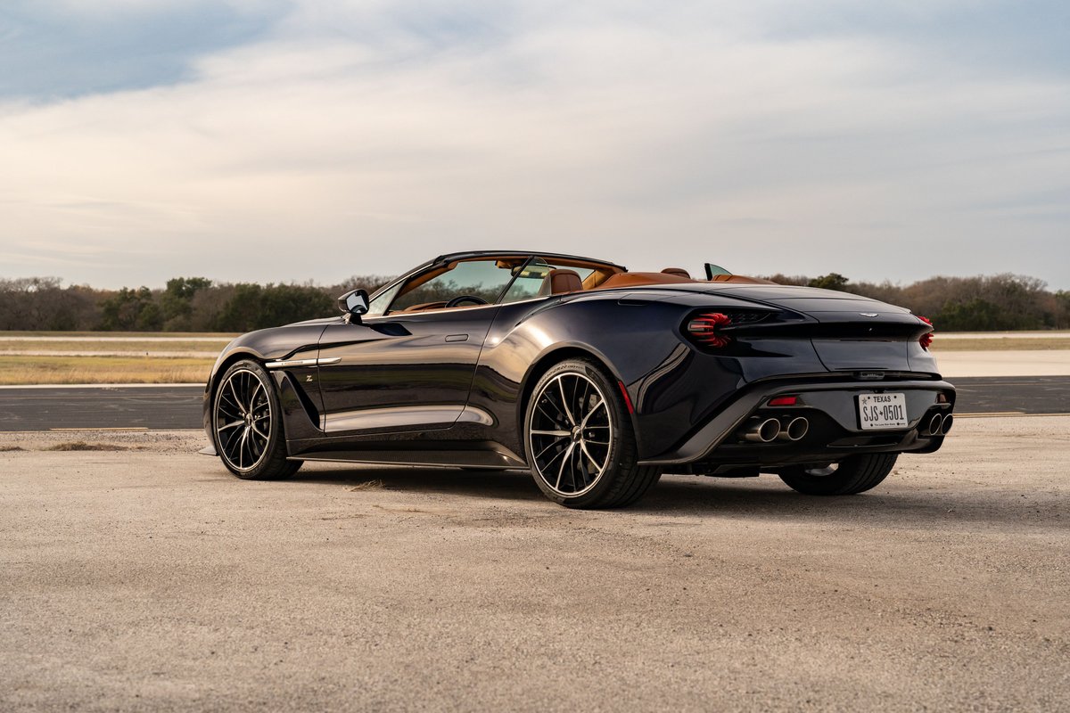 2018 Aston Martin Vanquish Zagato Volante in Orient Blue, rear 3/4 view, with black rims and tan interior.