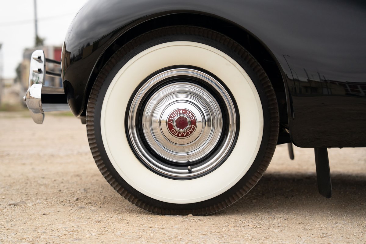 1940 Packard Super Eight One Eighty wheel with whitewall tire and chrome hubcap.