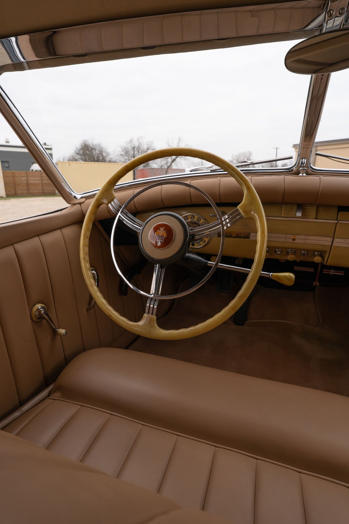 Interior of a 1940 Packard Super Eight One-Eighty, tan leather trim, horn ring steering wheel.