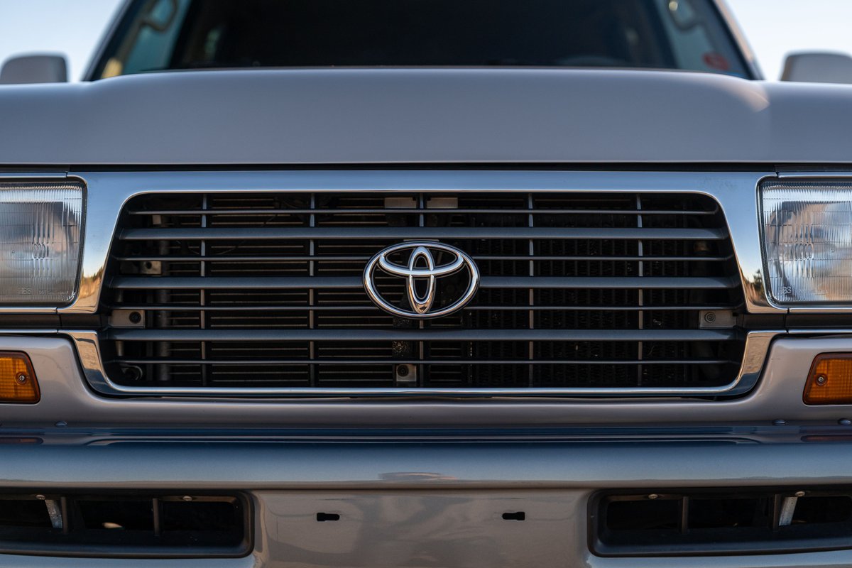 Front grille detail of a silver 1997 Toyota Land Cruiser FJZ80.