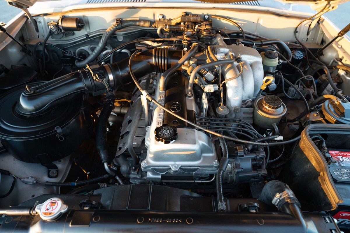 1997 Toyota Land Cruiser FZJ80 engine bay in Desert Dune Metallic.