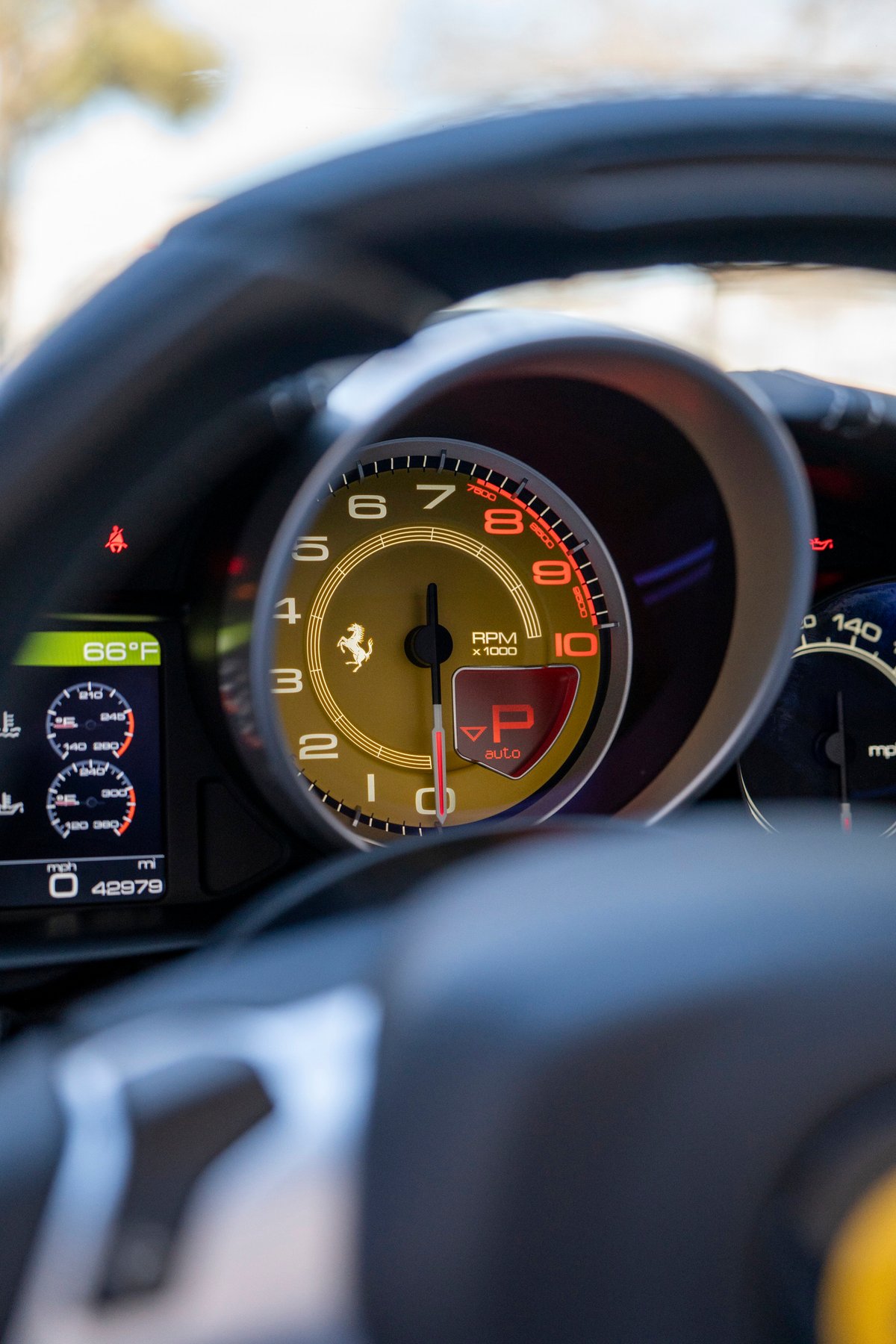 Ferrari California T dashboard showing RPM, speed, and gear selection.