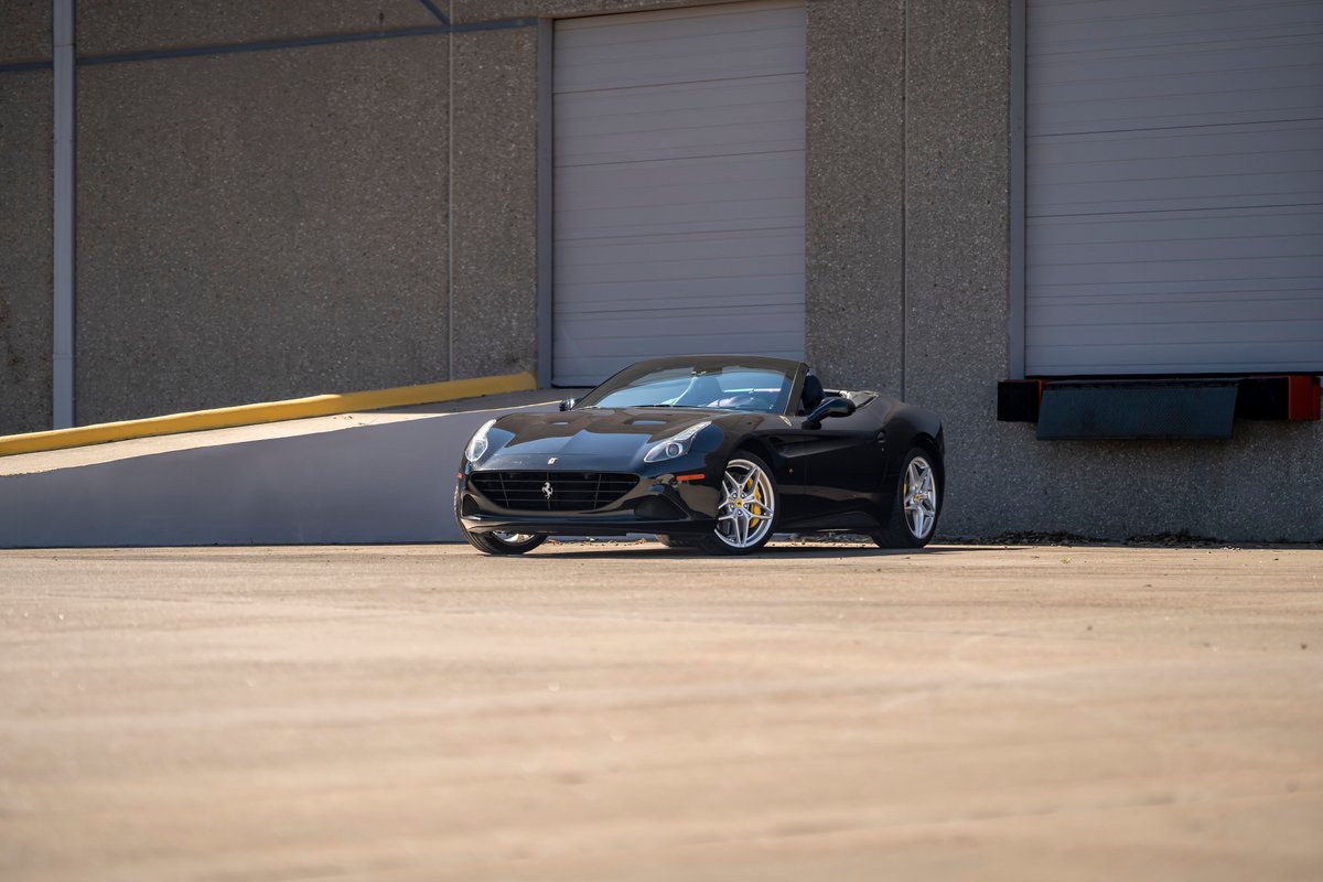Black 2016 Ferrari California T convertible with silver rims.