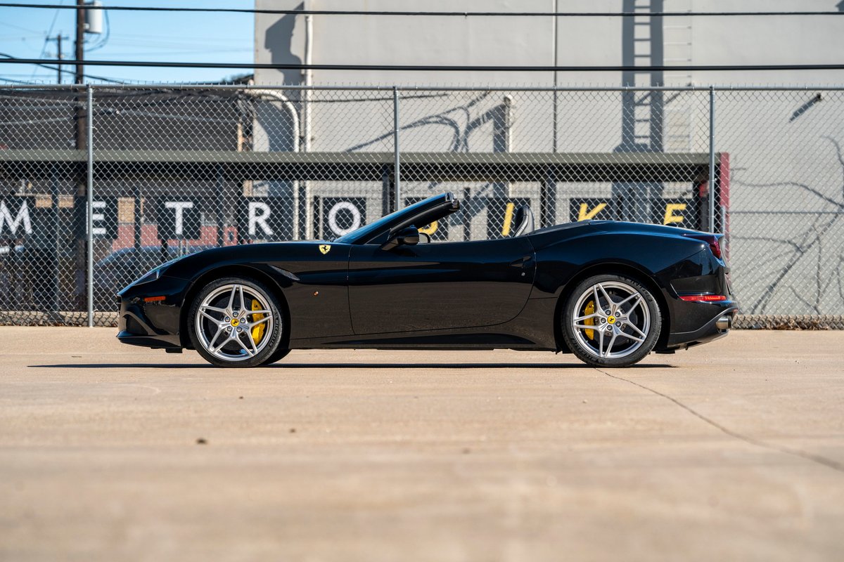 Black 2016 Ferrari California T with silver rims and yellow brake calipers.