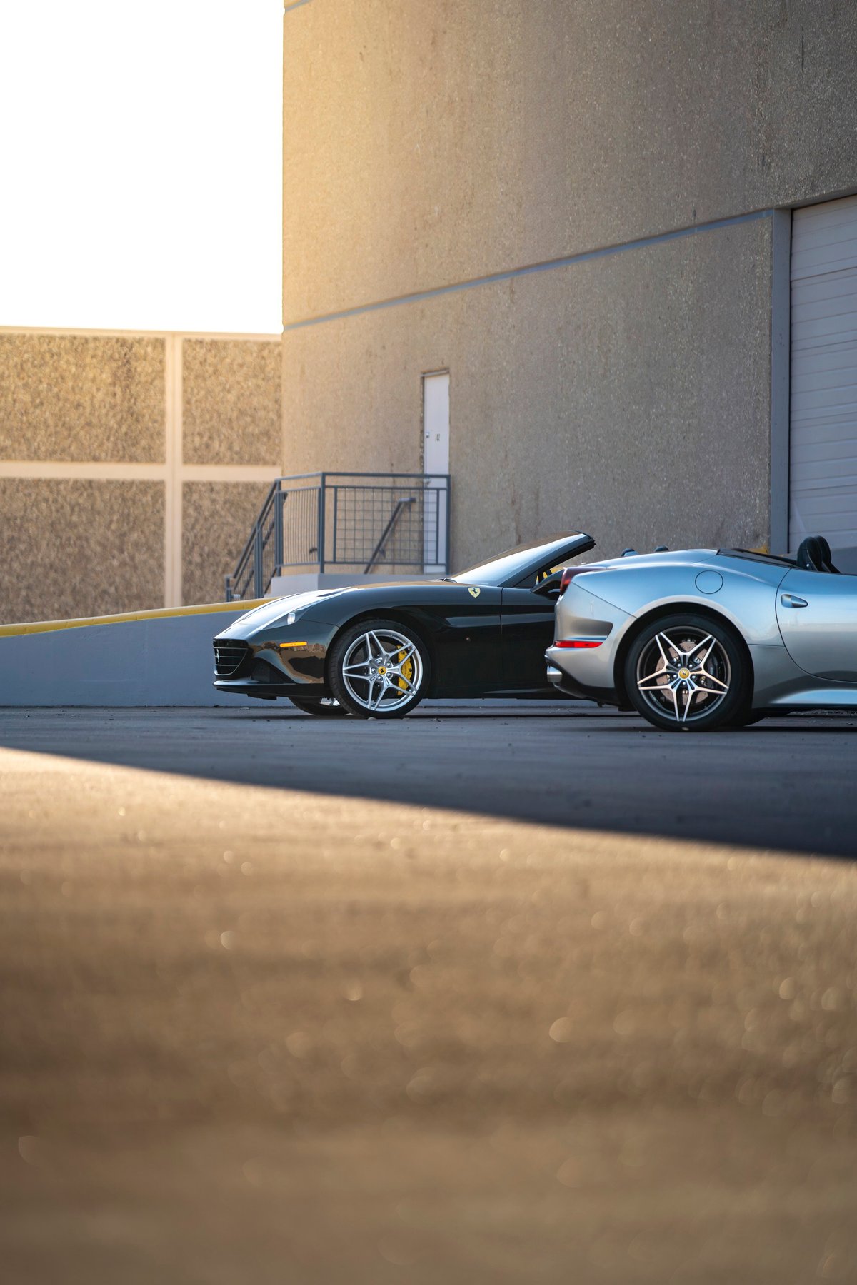 Black 2016 Ferrari California T convertible with silver rims and yellow brake calipers.