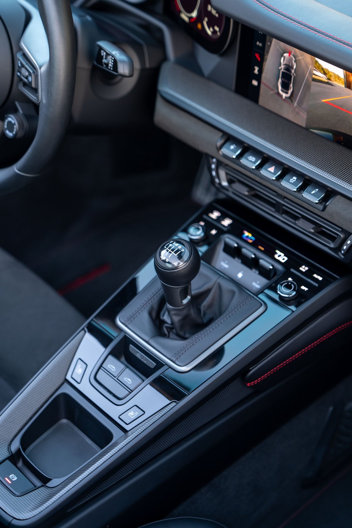 Interior view of a black 2023 Porsche 911 Carrera 4 GTS with a 6-speed manual transmission.