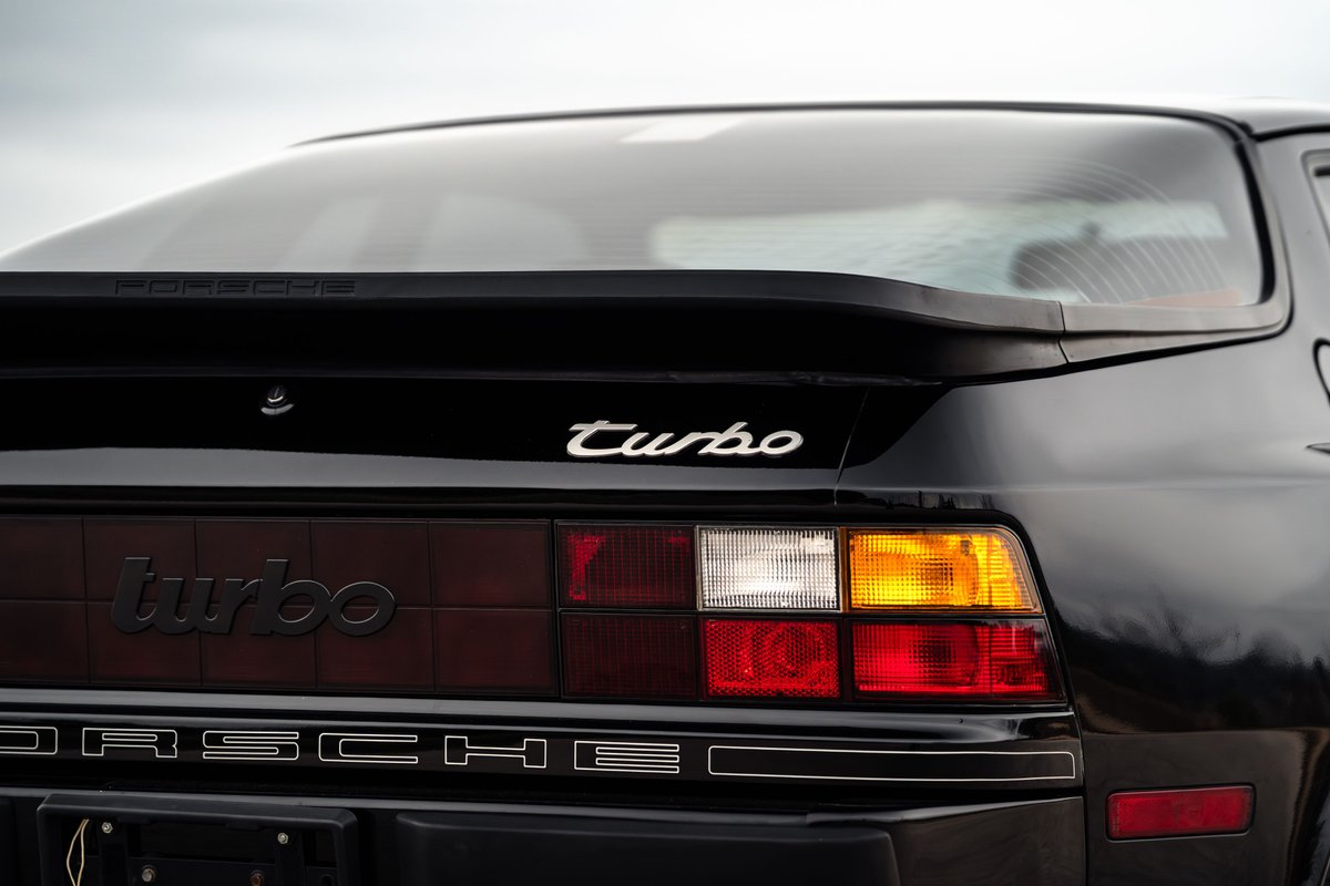 Black 1986 Porsche 944 Turbo rear view with "turbo" and "PORSCHE" badging.