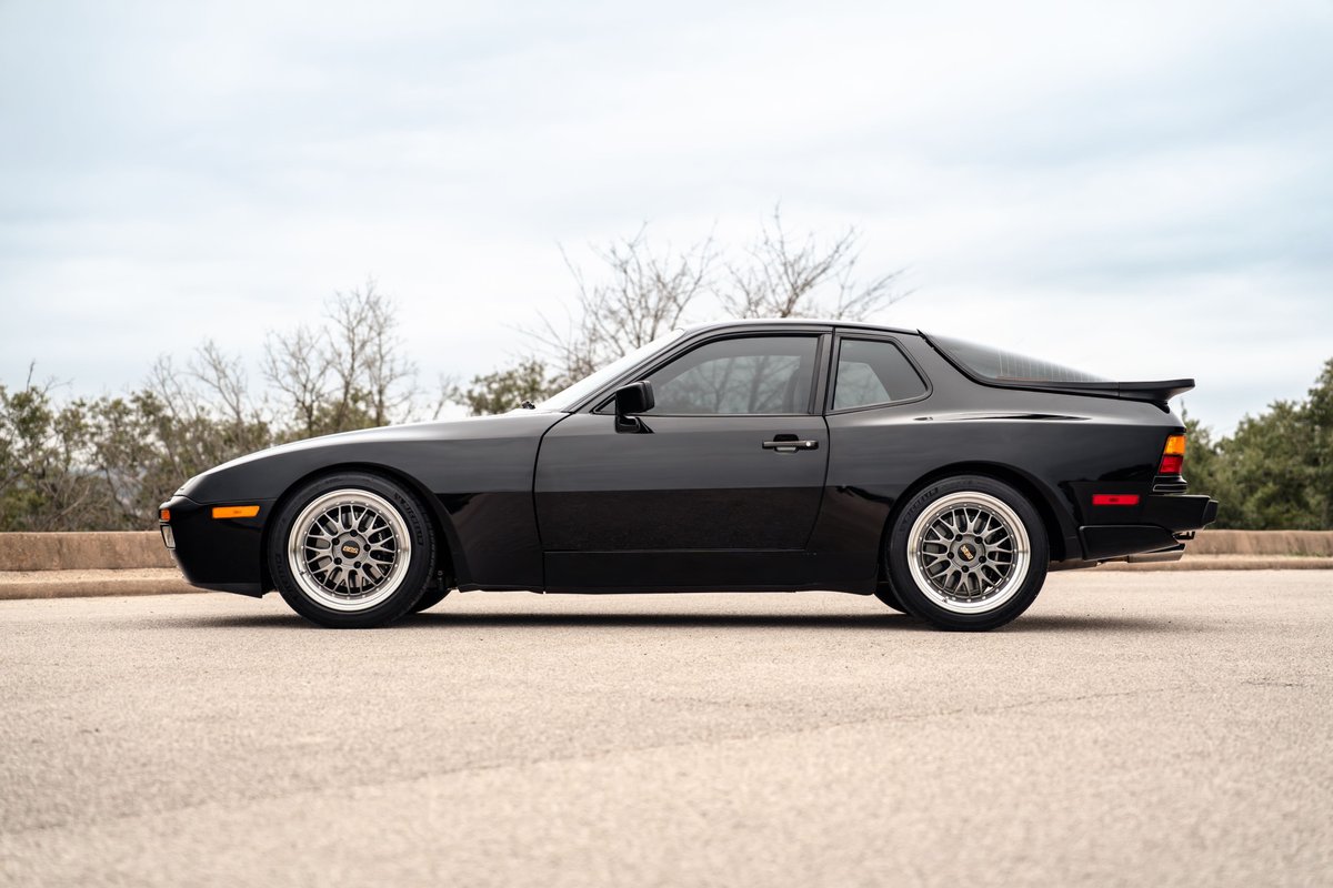 Black 1986 Porsche 944 Turbo Coupe with BBS mesh rims and rear spoiler.