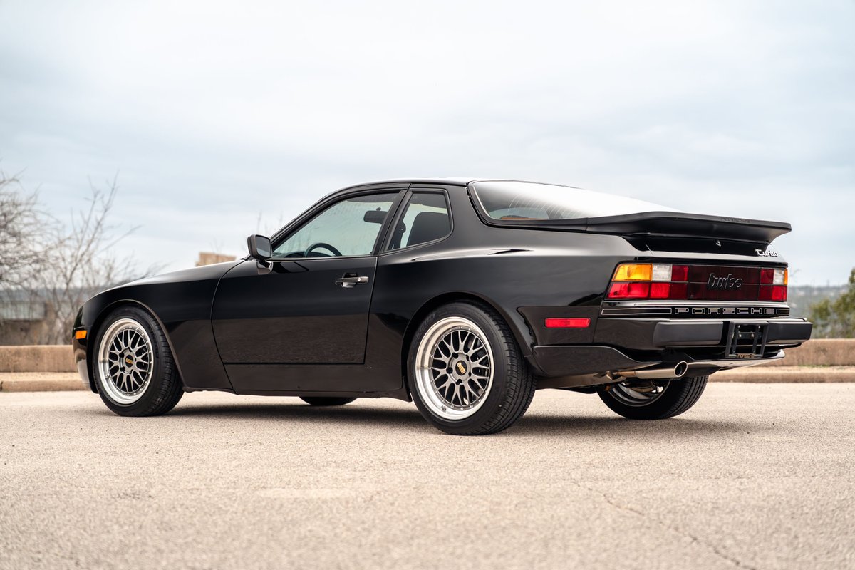 Black 1986 Porsche 944 Turbo with BBS-style rims and a rear spoiler.