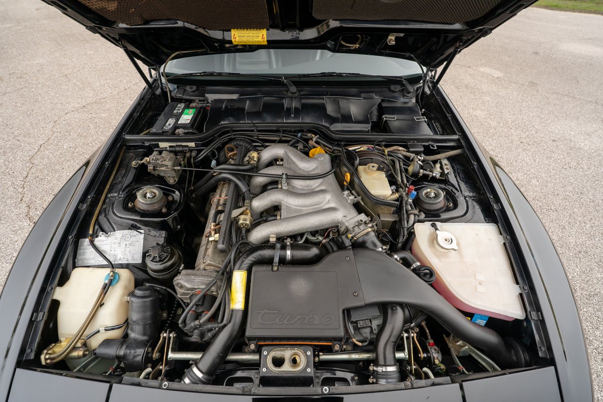 Black 1986 Porsche 944 Turbo engine bay with a 2.5L inline-4 engine.