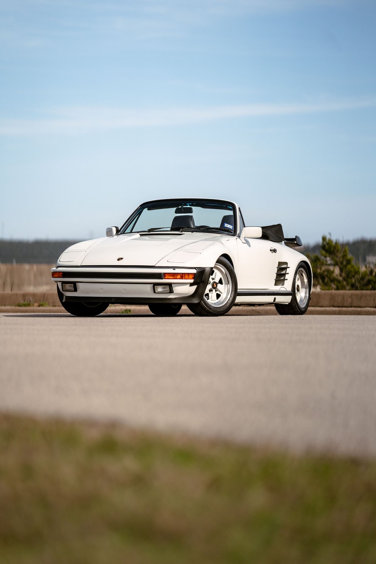 White 1988 Porsche 930 Turbo Slantnose convertible with Fuchs rims.