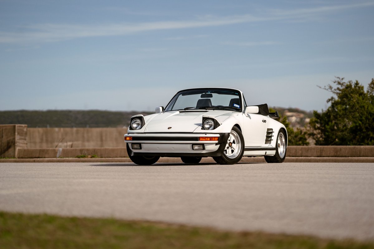1988 Porsche 930 Turbo Slantnose convertible in white, featuring polished Fuchs rims.