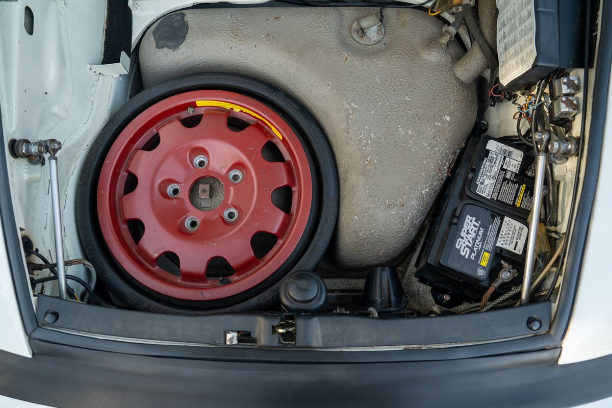 White 1988 Porsche 930 Turbo slantnose spare tire and battery compartment.