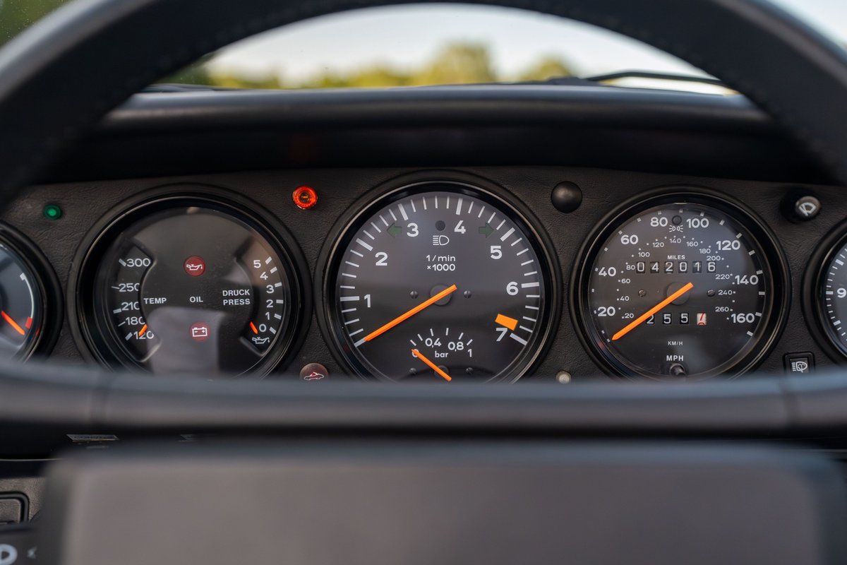 1988 Porsche 930 Turbo Slantnose dashboard with tachometer, speedometer, oil temp, and oil pressure gauges.