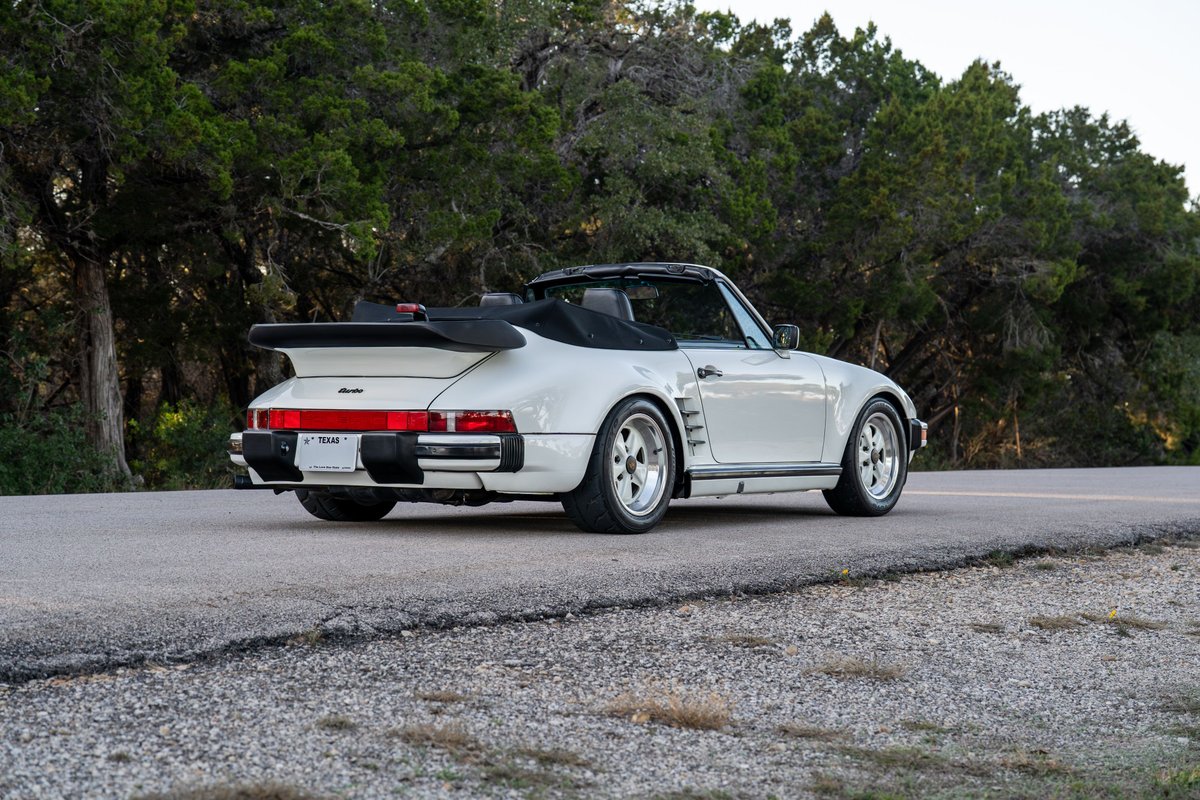 White 1988 Porsche 930 Turbo Slantnose convertible with Fuchs rims.