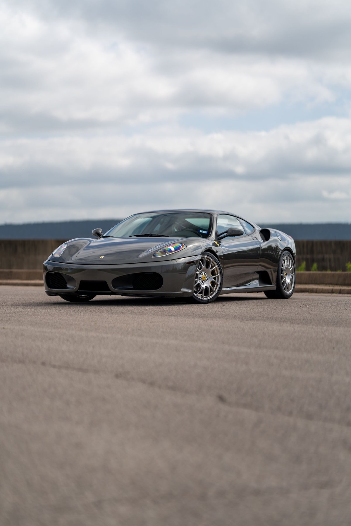 2007 Ferrari F430 in Grigio Silverstone with silver multi-spoke rims.