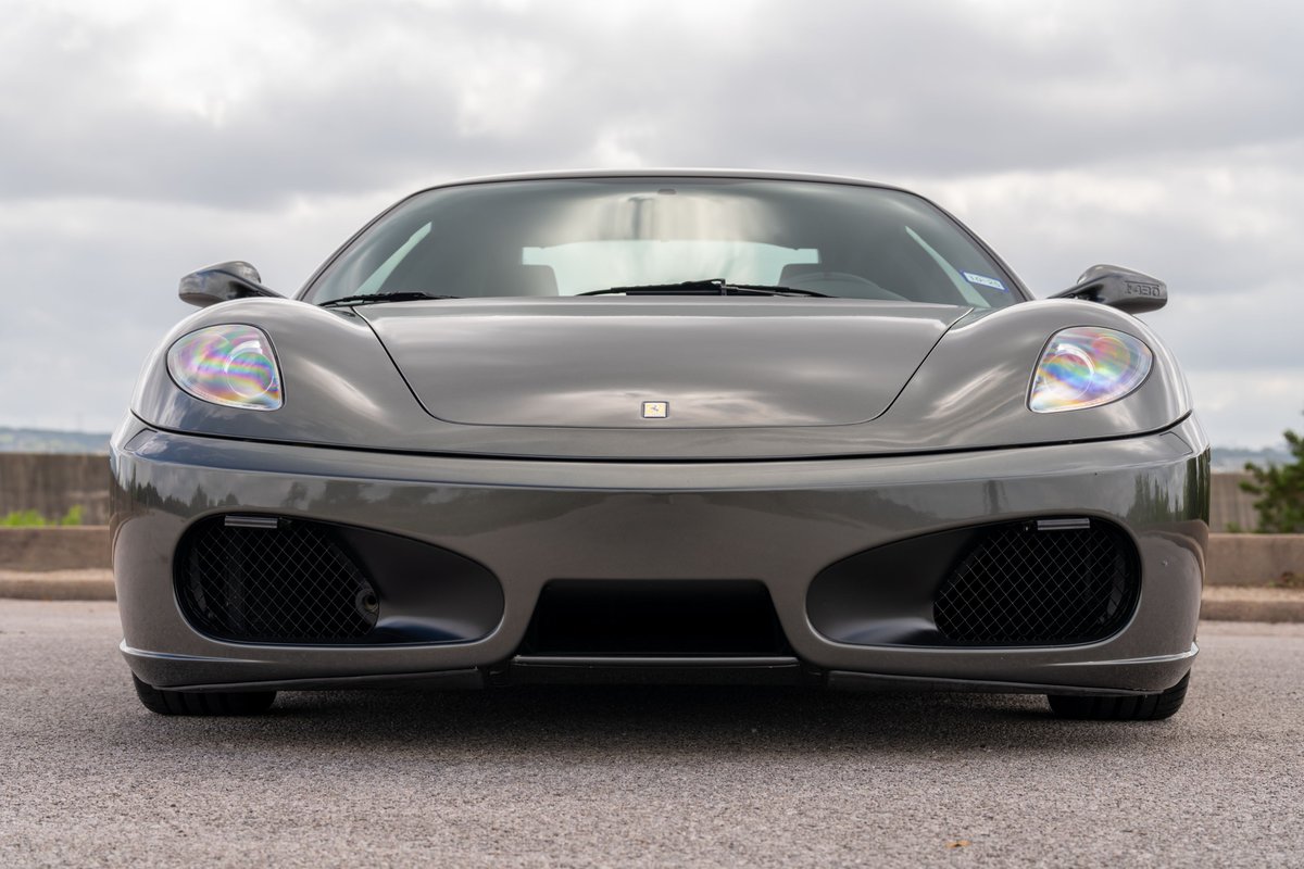 Grigio Silverstone 2007 Ferrari F430 front view, showcasing its sleek bodywork and aggressive front fascia.