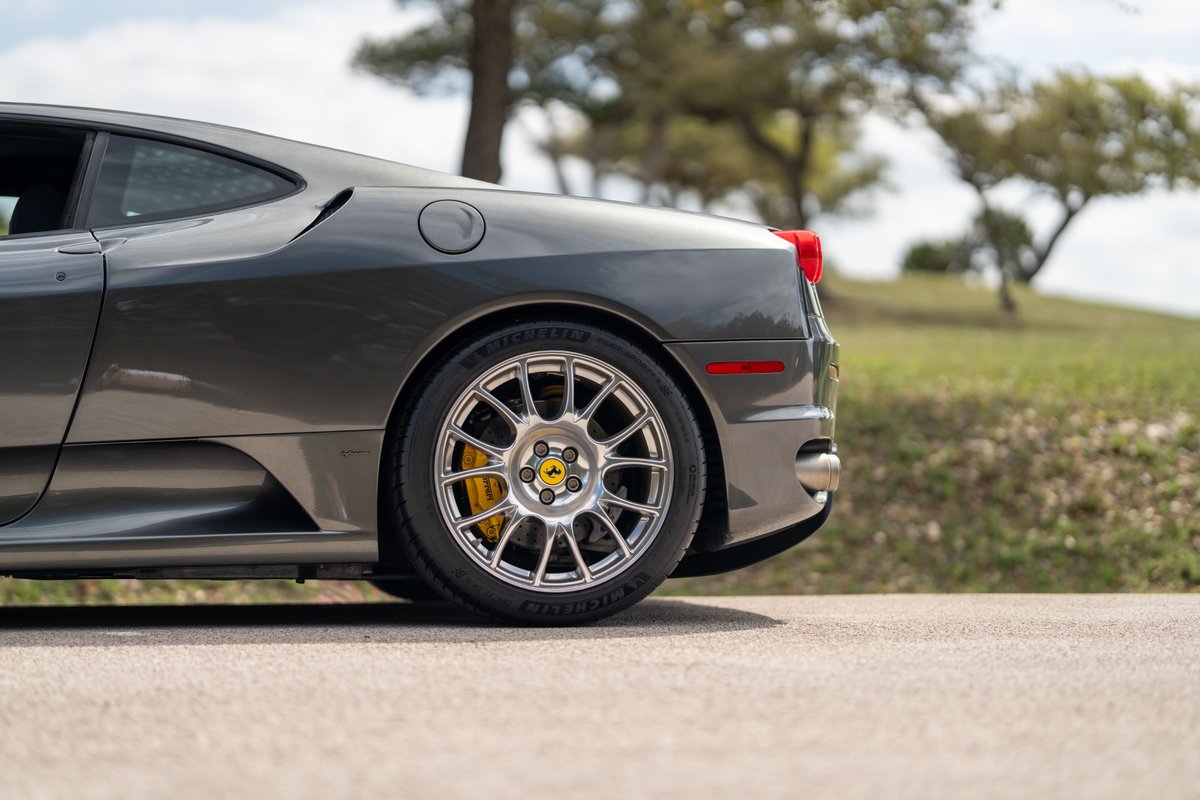 Gray 2007 Ferrari F430 with silver multi-spoke rims and yellow brake calipers.